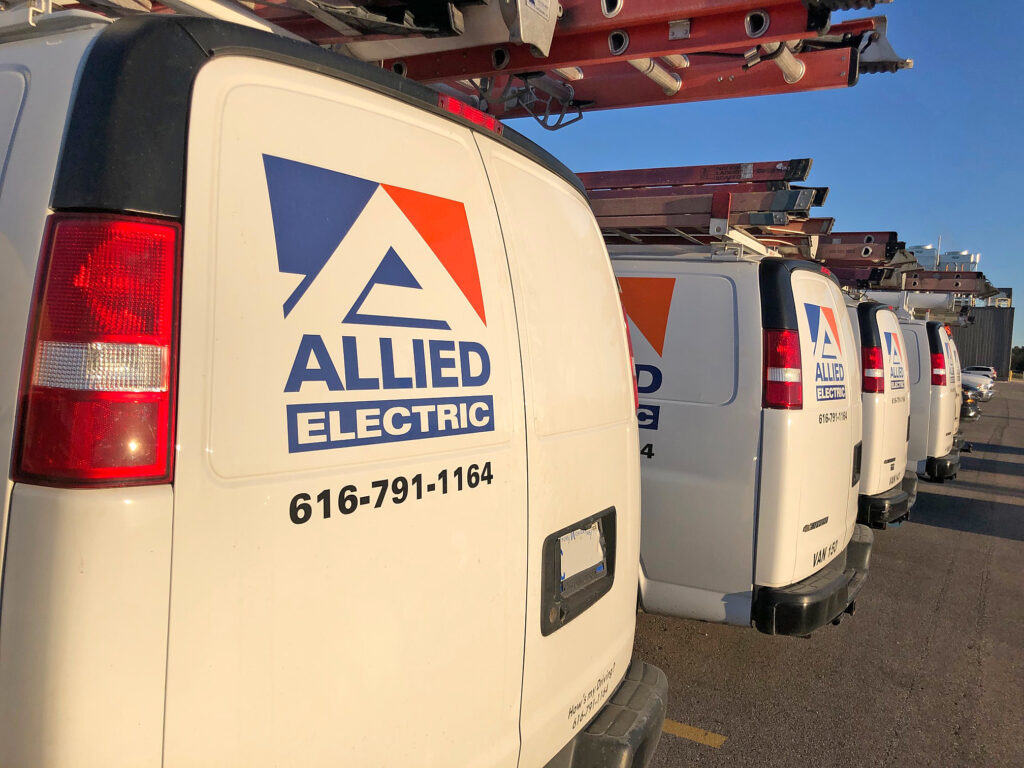 Allied Electric service vehicle fleet with ladder racks and equipment ready for deployment