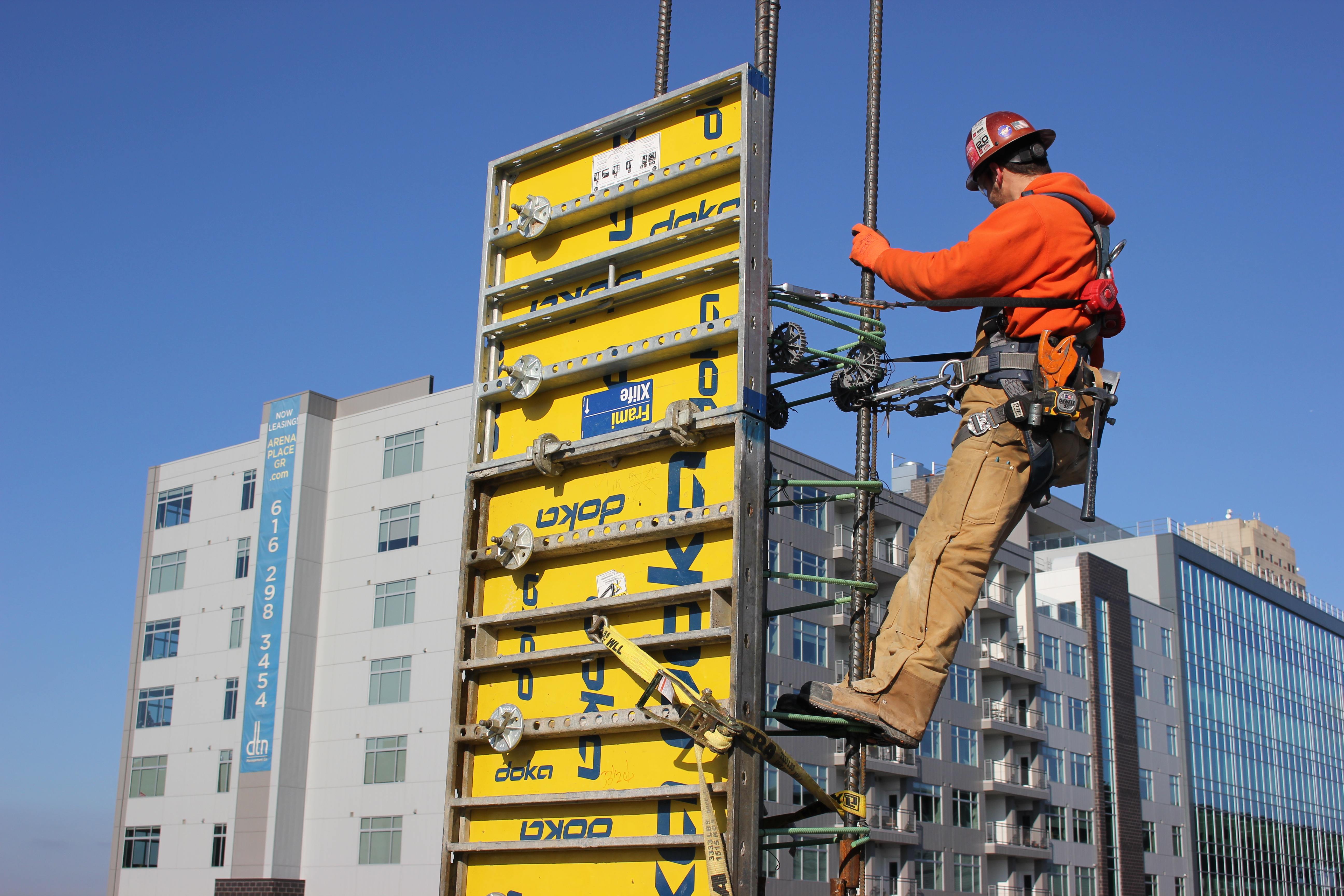 Construction worker in safety gear working on electrical equipment